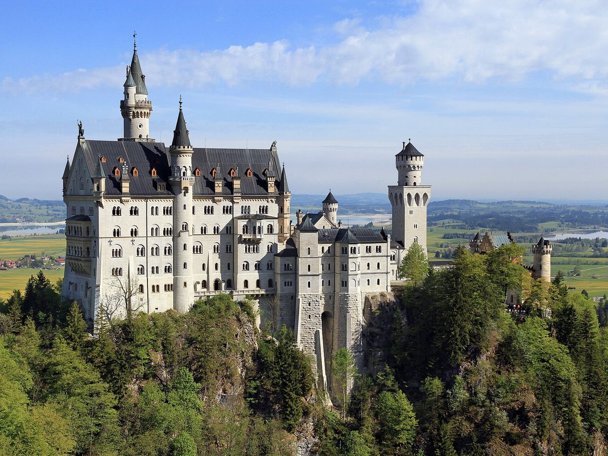 Neuschwanstein Castle above forested hills in Bavaria, Germany